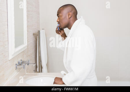 Young man brushing his teeth Stock Photo