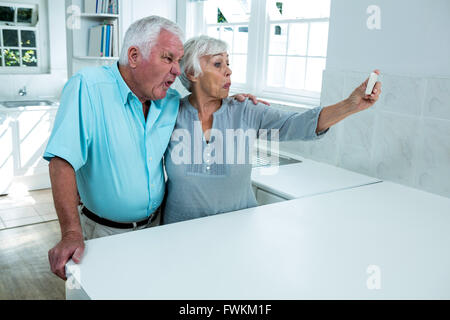 Playful retired couple taking selfie Stock Photo