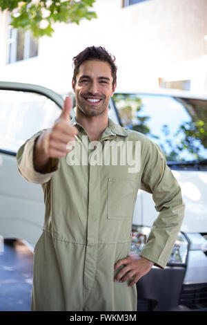 Portrait of smiling pesticide worker showing thumbs up Stock Photo