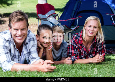 Portrait of happy family lying on grass Stock Photo