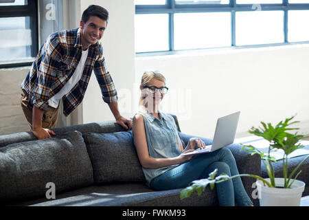 Colleagues sitting on the sofa in the office Stock Photo