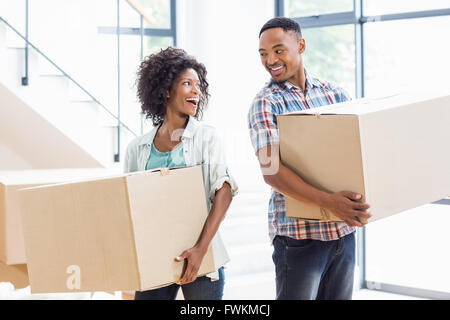 Smiling young couple holding a carton in their new house Stock Photo