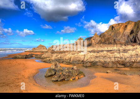 Sandymouth beach North Cornwall England UK beautiful rocks with unusual patterns in colourful HDR Stock Photo