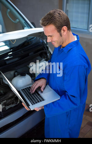 Mechanic using a laptop Stock Photo