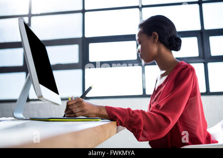 Woman working on her graphics tablet Stock Photo