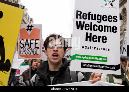 Protesters holding placards: 'Refugees Welcome Here; Safe Passage#' Stock Photo