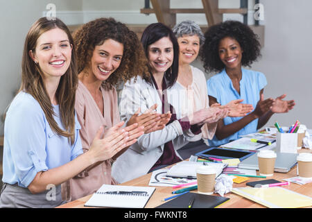 Group of interior designers applauding in office Stock Photo