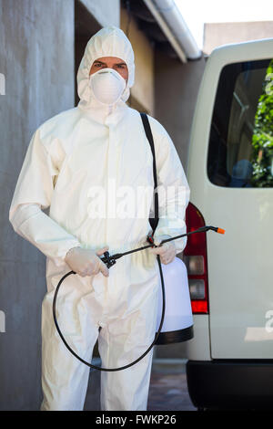 Pest control man standing behind a van Stock Photo