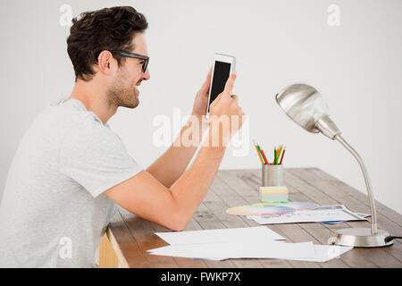 Young man using digital at his desk Stock Photo