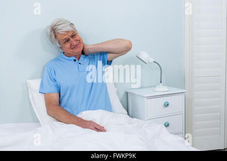 Senior man suffering from neck pain Stock Photo