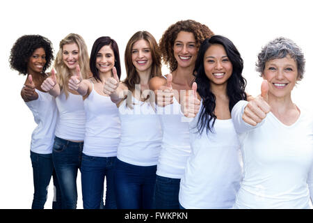 Happy multiethnic women standing in a line and showing thumbs up Stock Photo