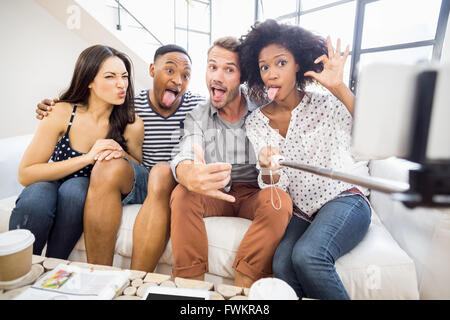 Friends making funny faces while taking a selfie Stock Photo