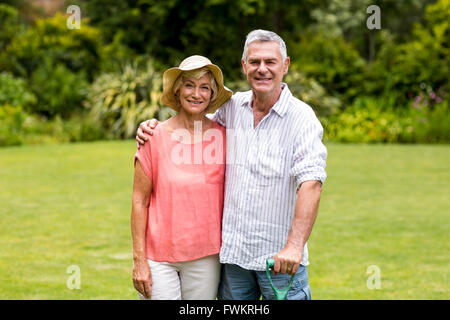 Senior couple standing at yard Stock Photo