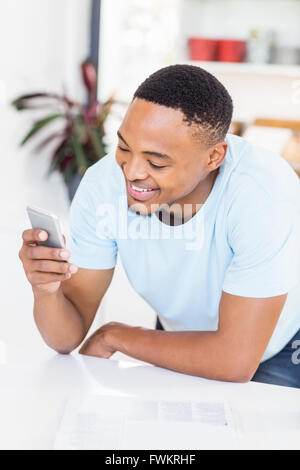 Happy man text messaging on mobile phone Stock Photo
