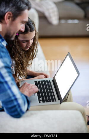 Father and daughter using laptop Stock Photo