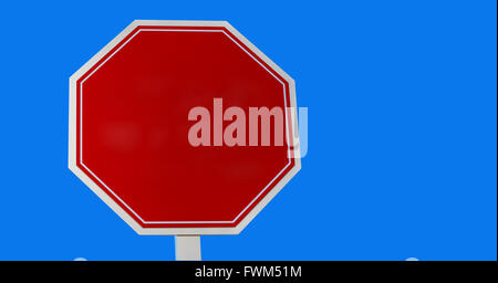A blank red stop sign on a blue background Stock Photo