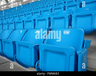 Hundreds of blue folding chairs in large stadium Stock Photo