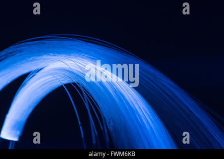 optical fibres dinamic flying from deep on technology background Stock Photo