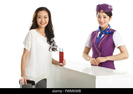 Young female flight attendants and passengers Stock Photo