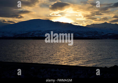 golden vibrant sunset over snowy mountain and fjord landscape Stock ...