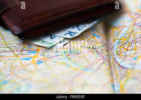 Euro banknotes inside wallet on a geographical map of Cologne, Germany Stock Photo