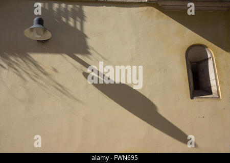 evening shadow casts a long shadow from a street lamp Stock Photo