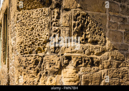 Erosion has taken its toll of these old exterior cottage walls in Lacock Wiltshire UK Stock Photo