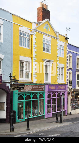 Colourful shop fronts in the high street. Glastonbury, Somerset, England Stock Photo