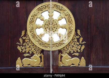 chinese style wooden door with golden ornamental at dragon temple in Thailand Stock Photo