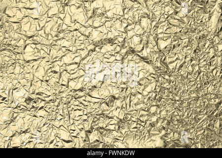Pattern of Wrinkled Gold Aluminium Foil Paper using as background Stock Photo