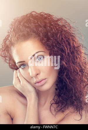 Beautiful young woman with red curly hair Stock Photo