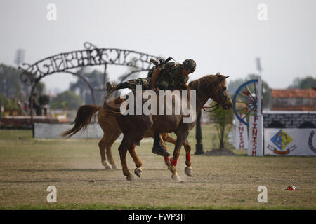 Kathmandu, Nepal. 7th Apr, 2016. A Nepalese Army soldier perform stunts during Ghode Jatra festival or Horse Parade in Tundikhel grounds, Kathmandu, Nepal on Thursday, April 7, 2016. According to myths it is said that Ghode Jatra is celebrated as triumph over demon that once was a horror in the city and by galloping horses the demon spirit stays under the ground. Credit:  Skanda Gautam/ZUMA Wire/Alamy Live News Stock Photo