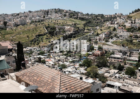 Jerusalem, Israel. 7th April, 2016. A view of Silwan and the Kidron Valley from the rooftop of what Jewish residents call Bet Frumkin. An estimated 500 Israeli Jews currently live in Kfar Shiloach among 45,000 Palestinian Arabs who call the village Silwan and consider the Jews illegal settlers. Most land deals were orchestrated by Ateret Cohanim, an Israeli Jewish organization, which works for the creation of a Jewish majority in the Arab neighborhoods in East Jerusalem, claiming all land deals legitimate and legal. Stock Photo