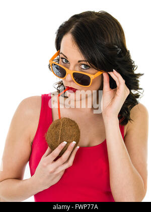 Attractive Healthy Young Woman Drinking From A Fresh Coconut Isolated Against a White Background Stock Photo