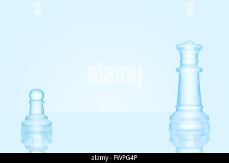 Leadership and bravery concept; an icy frosted single pawn staying against a queen on chessboard. Stock Photo