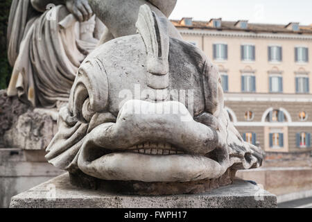 Ancient sculpture with fish on the Piazza del Popolo square, old city center of Rome, Italy Stock Photo