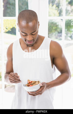 Young man having breakfast cereals Stock Photo