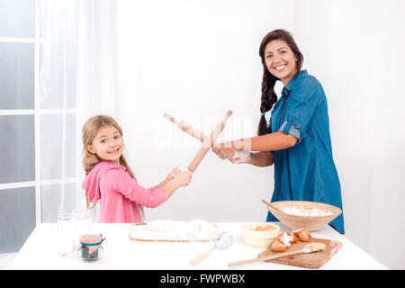 Happy mother and daughter baking