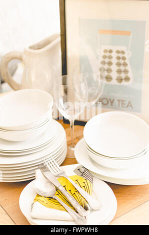 crockery on a table, wine glasses and plates with cutlery Stock Photo