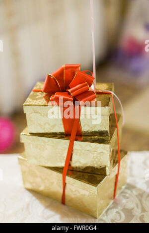 A stack of gold gift boxes on birthday or wedding party Stock Photo