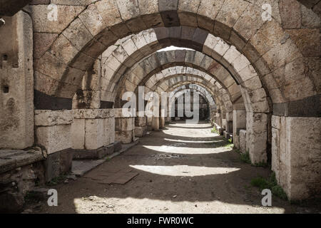 Empty stone corridor with arcs and columns. Ruins of Ancient city Smyrna. Izmir, Turkey Stock Photo