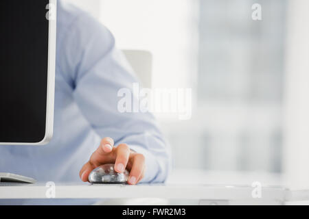 Mid-section of mans hand working on computer Stock Photo
