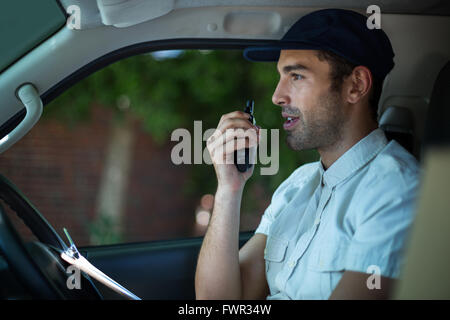 Delivery man using walkie-talkie Stock Photo