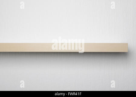 An empty wooden shelf on a white wall Stock Photo