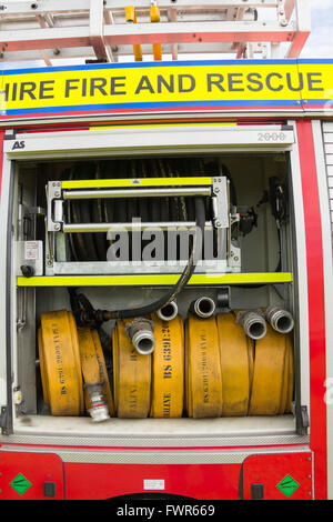 Compartment of rolled fire hoses on a fire engine. The vehicle is a DAF LF series truck with coachwork by Browns of Lisburn. Stock Photo