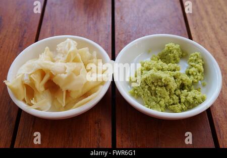 Dishes of green wasabi, pickled ginger and soy sauce Japanese condiments Stock Photo