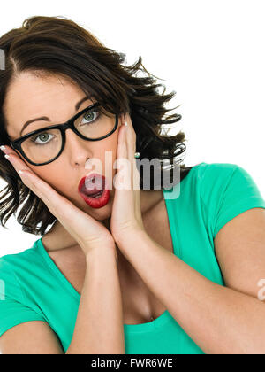 Shocked Surprised Young Woman holding Her Head With Her Hands And Mouth Open in shock horror Stock Photo