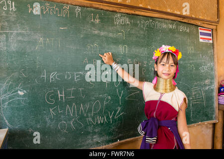 Girl with neck rings at school, Padaung hilltribe, long-necked women, schoolgirl pointing at a blackboard, Chiang Rai Province