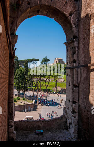 View through an arch of the Colosseum on the square Colosseum Stock Photo