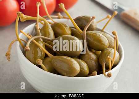 Bowl with pickled caperberries close up Stock Photo